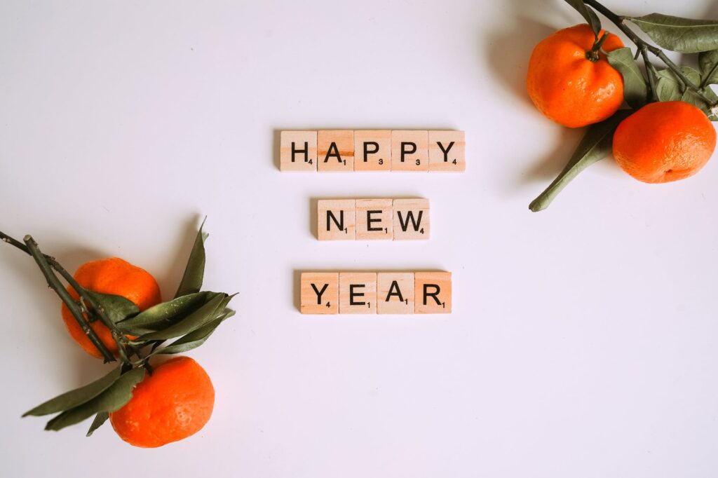 letter tiles beside mandarins